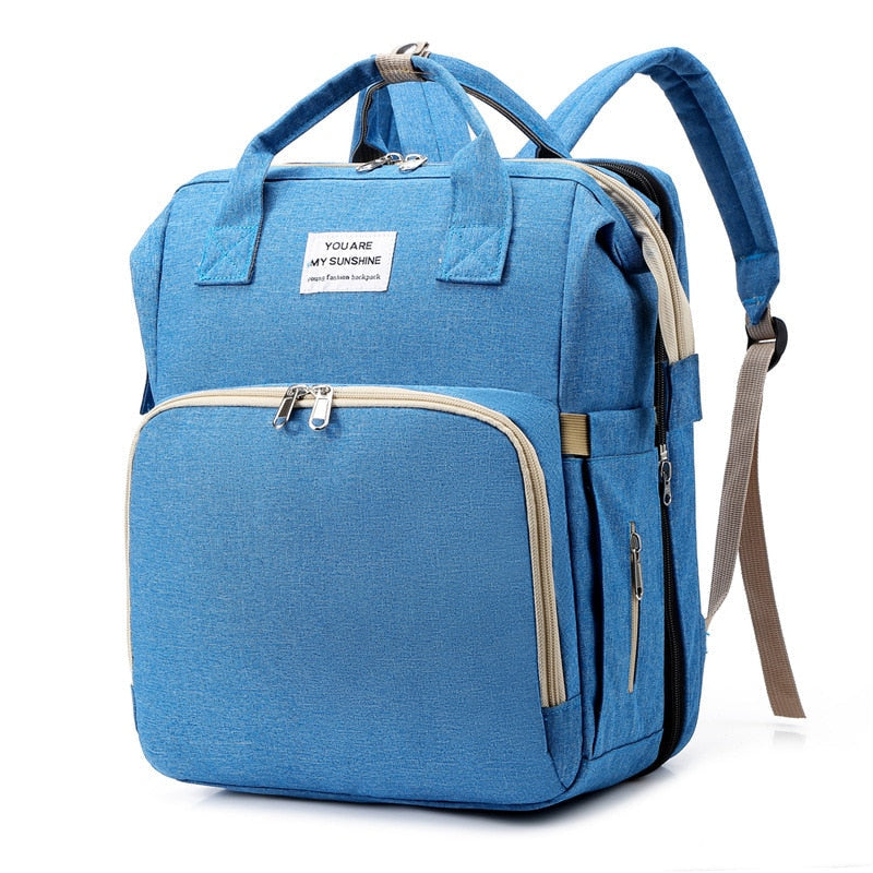 Unisex reiseveske for baby med smart glidelåsdesign, transformert til en praktisk bærbar seng for reise.