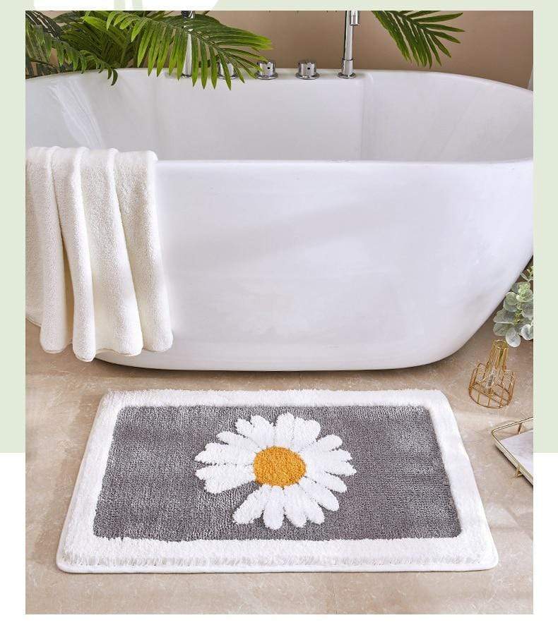 Absorberende baderomsmatte med tusenfryd motiv. Sklisikker bakside, myk mikrofiber og slitesterk badeinnredning.