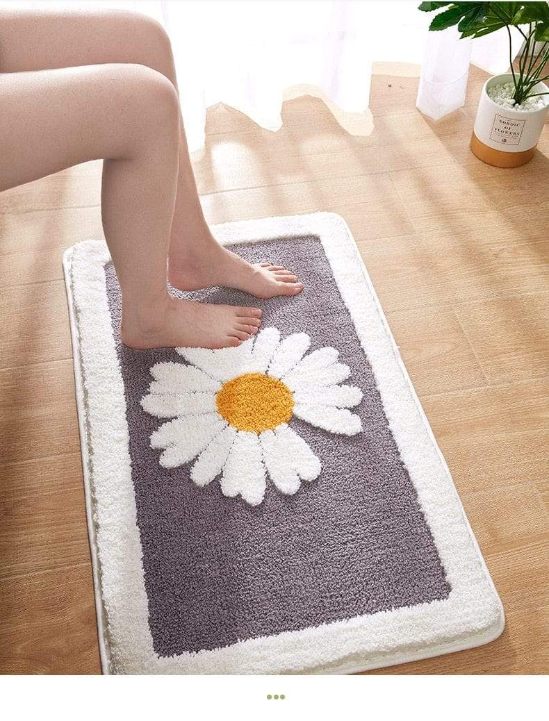 Hvit baderomsmatte med detaljerte tusenfryd. Funksjonell, dekorativ og lett å vaske for ditt baderom.