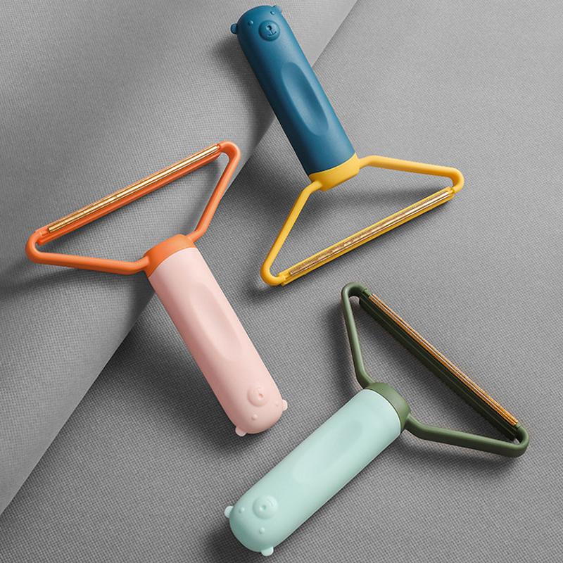 "Effektiv batteriløs lo- og nuppefjerner i blått, grønt og rosa, kompakt design, fjerner lo uten å skade stoffet."