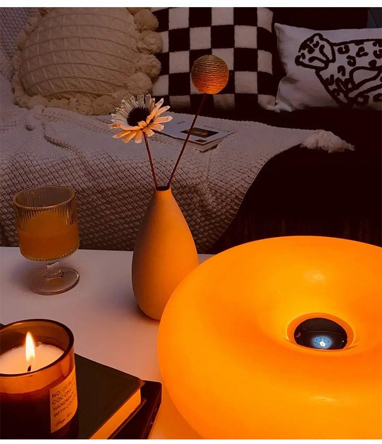 "Elegant Bauhaus Donut lampe i hvit og oransje, dimmbart lys, vegg- og bordbruk. Flott til moderne interiør."
