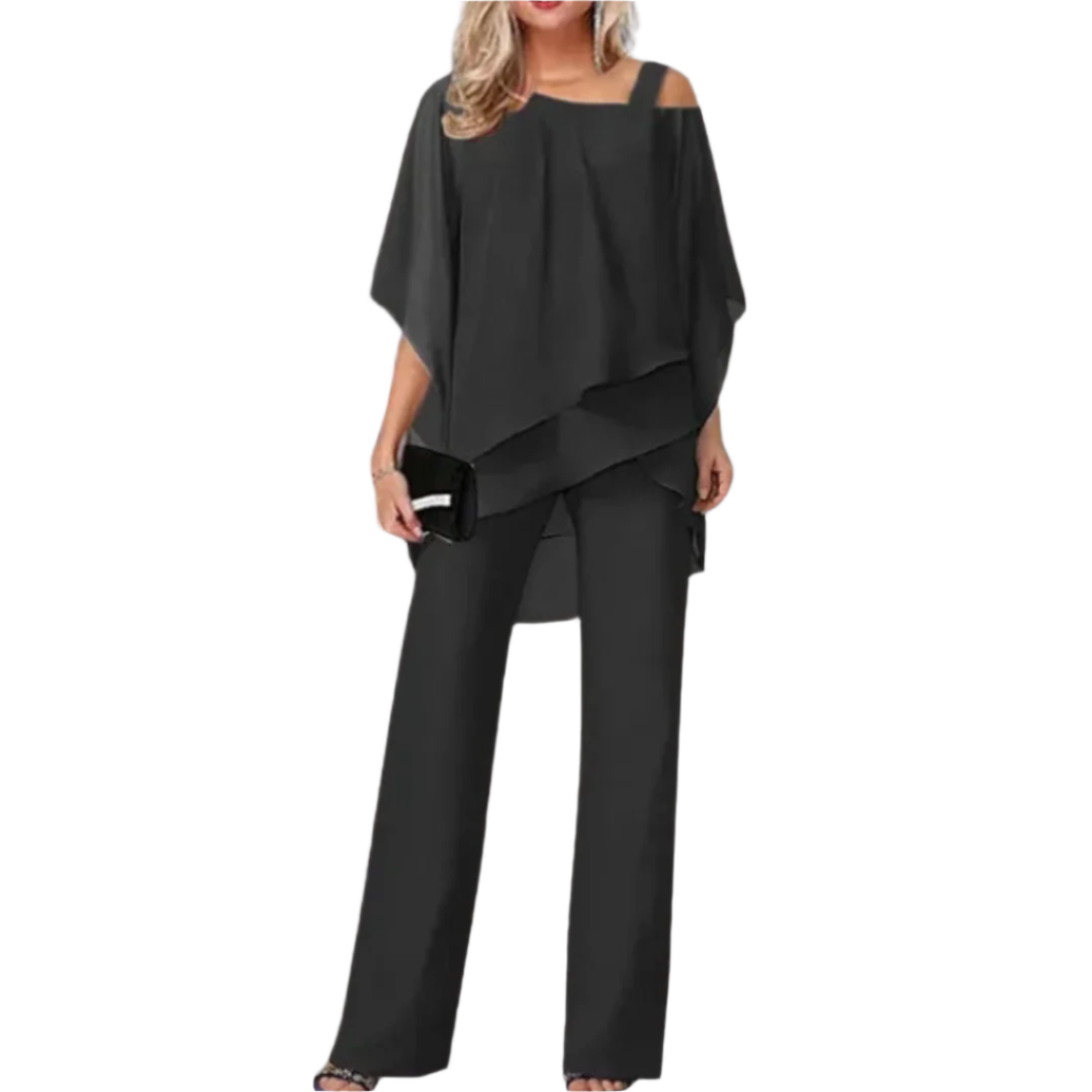 Elegant kvinne ensemble med asymmetrisk topp og bred bukse for festlige anledninger.