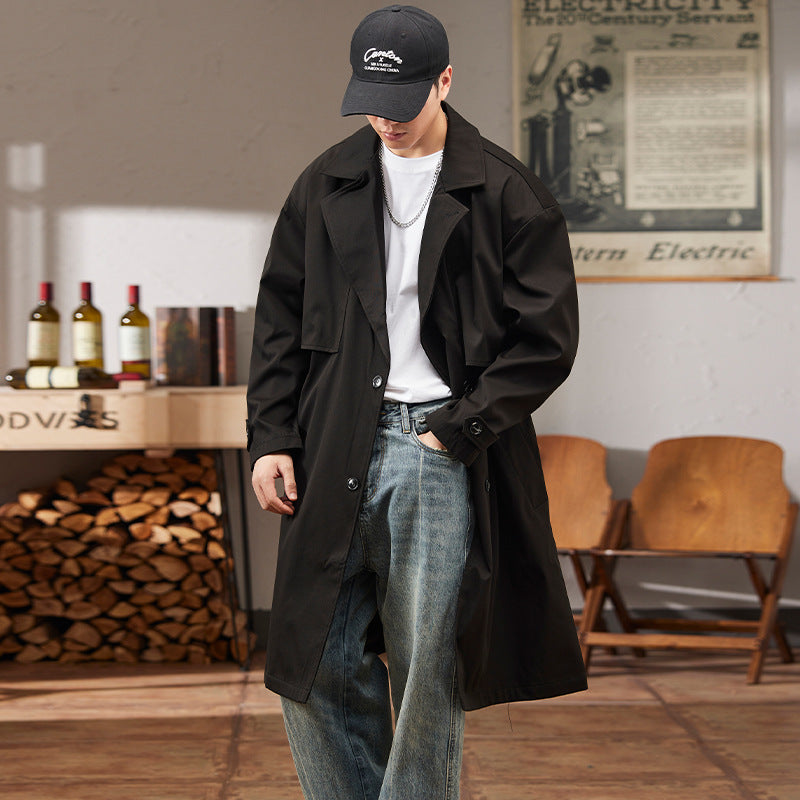 "Elegant lang herre trenchcoat med justerbar passform, sett forfra. Perfekt for moderne stil og værbeskyttelse."