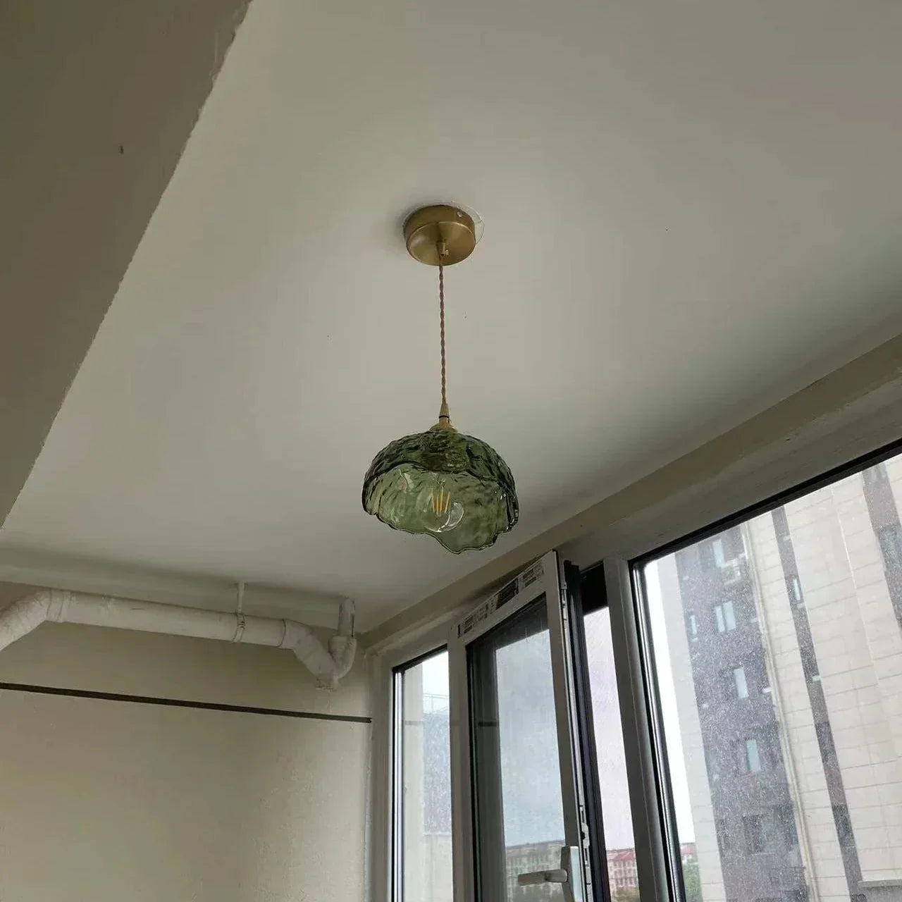 "Elegant pendellampe i messingglass med moderne design, perfekt for å skape stilfull belysning i hjemmet ditt."