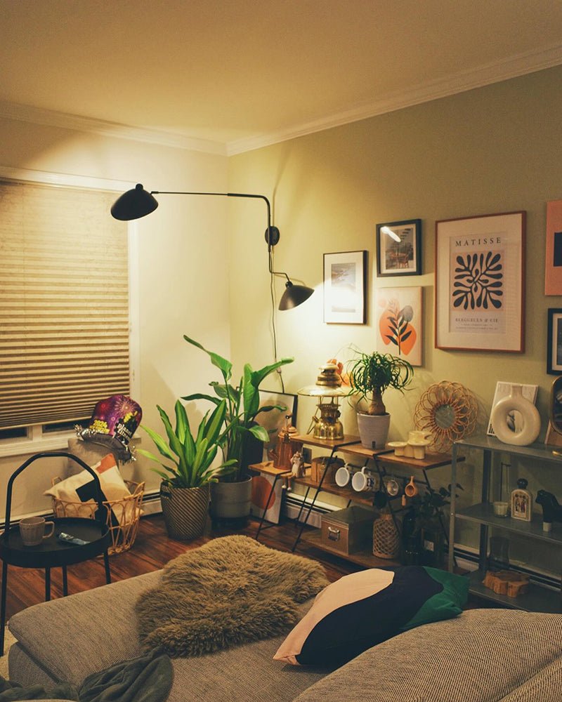 "Elegant Serge Mouille vegglampe med justerbar arm, insektlignende design, passer moderne innredning i svart eller hvit."