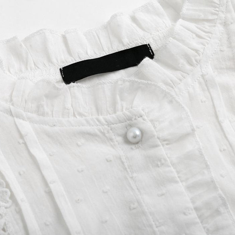 "Elegant utsvinget bomullsbluse for kvinner med raffinert krage og lange ermer, perfekt for høstsesongen."