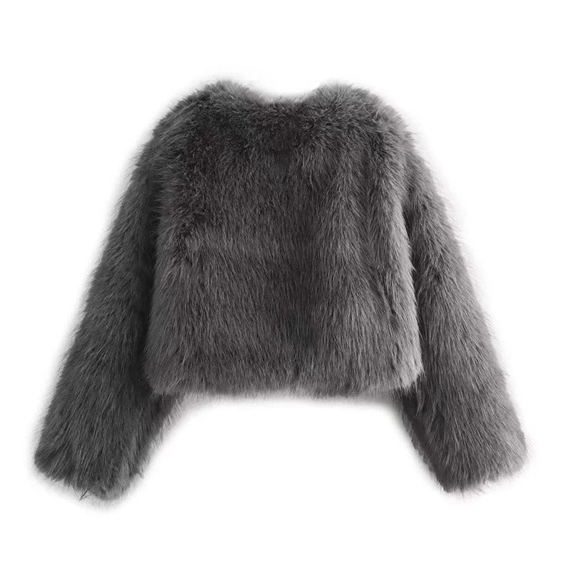 Nærbilde av stoffet på varm dame vinterjakke, myk tekstur, elegant og komfortabel.