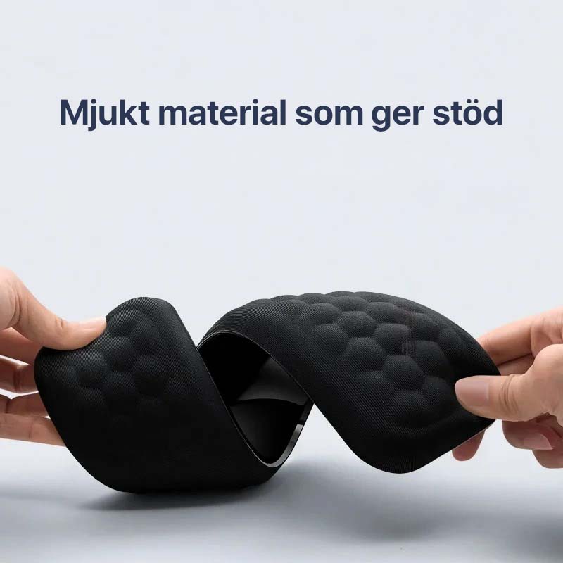 Håndleddsstøtte i memory foam plassert foran et tastatur og mus, ideell for datamaskinbruk.