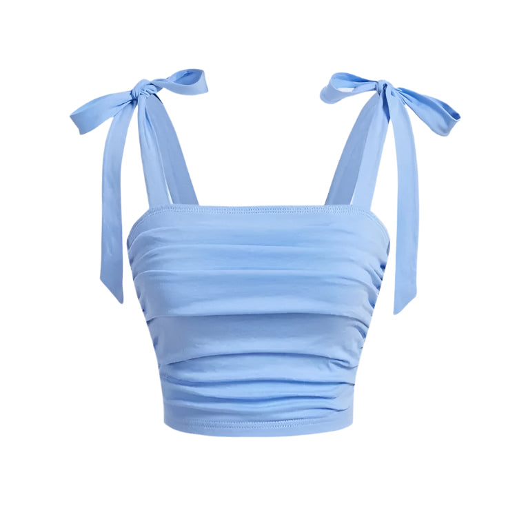 Rosa crop top for dame med lekre rysjer og justerbare bindeskuldre. Ideell for fritid og varme dager.