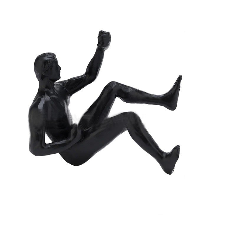"Klatrende svart veggstatue i 3D resindesign, gir kunstnerisk preg og dybde til hjemmets interiør. Enkel installasjon."