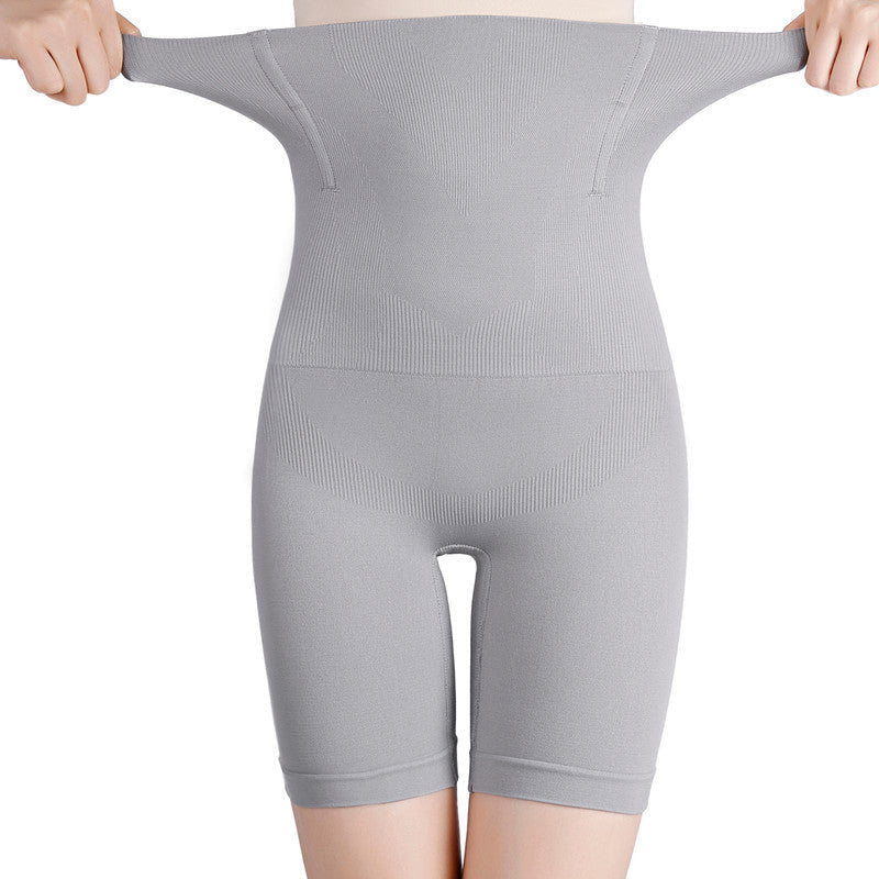 "Mageformende og sømløs underbukse med høy midje, elegant design, sett fra siden, i rød variant for kvinner."