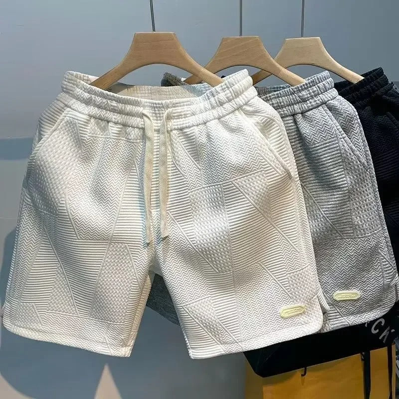 Ensfargede menns løse sportsshorts med lommer, optimal for bevegelsesfrihet under trening og fritidsaktiviteter.