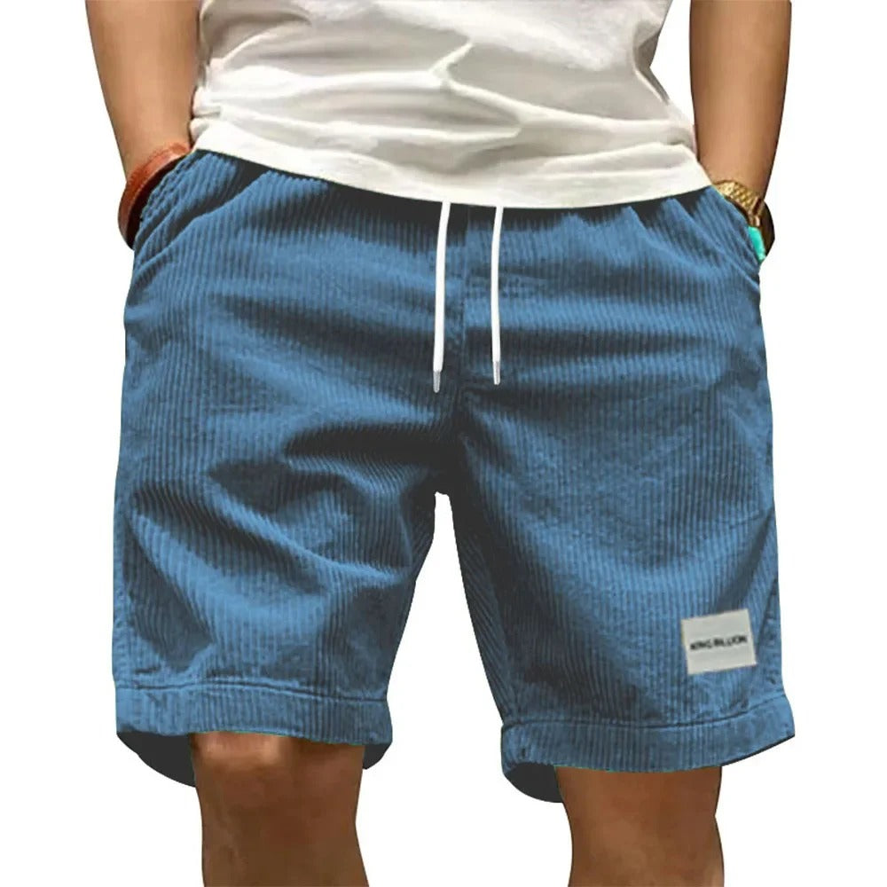 Detaljebilde av teksturert stoff på menns retro shorts. Med praktiske lommer og behagelig passform.