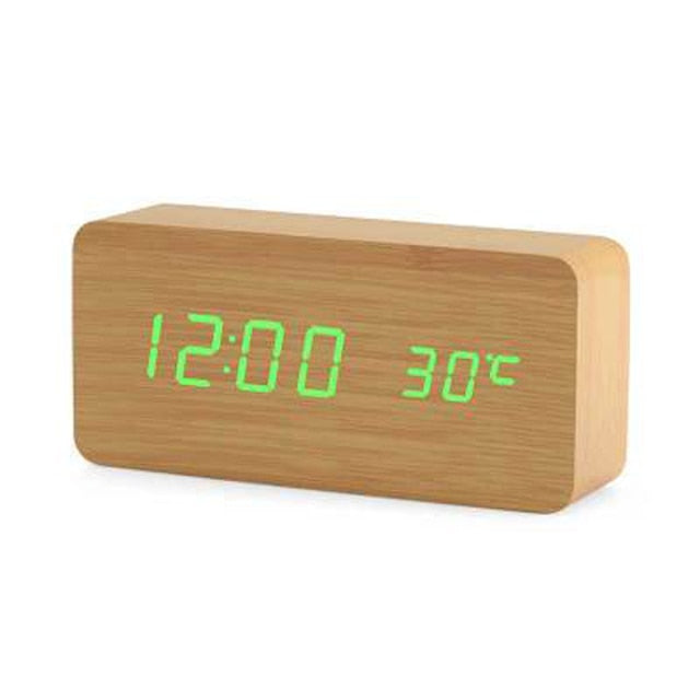 Oversiktsbilde av minimalistisk digital vekkerklokke på nattbord, klart LED-display, sort finish.