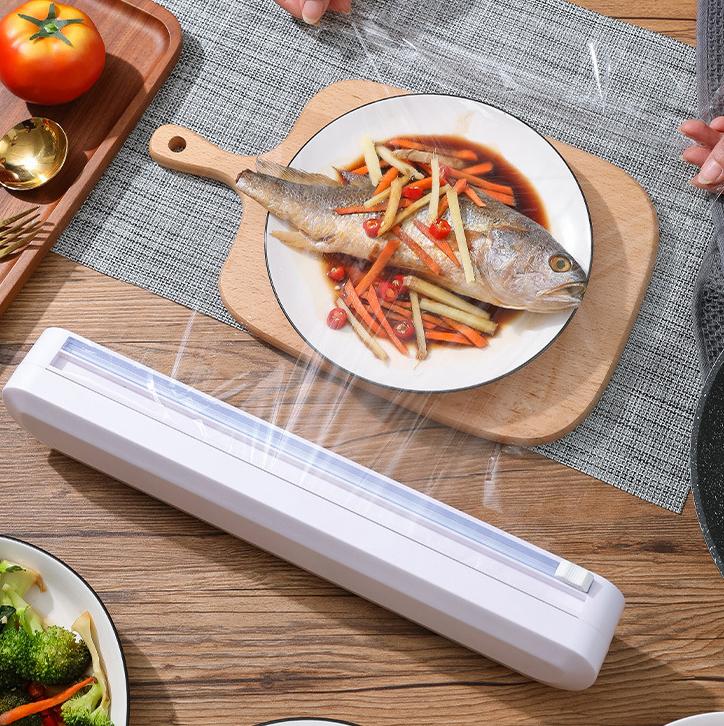 "Plastfoliekutter på kjøkken, slitesterkt ABS, moderne design med toveis kutterhode, sikker bunn med mikrosug."