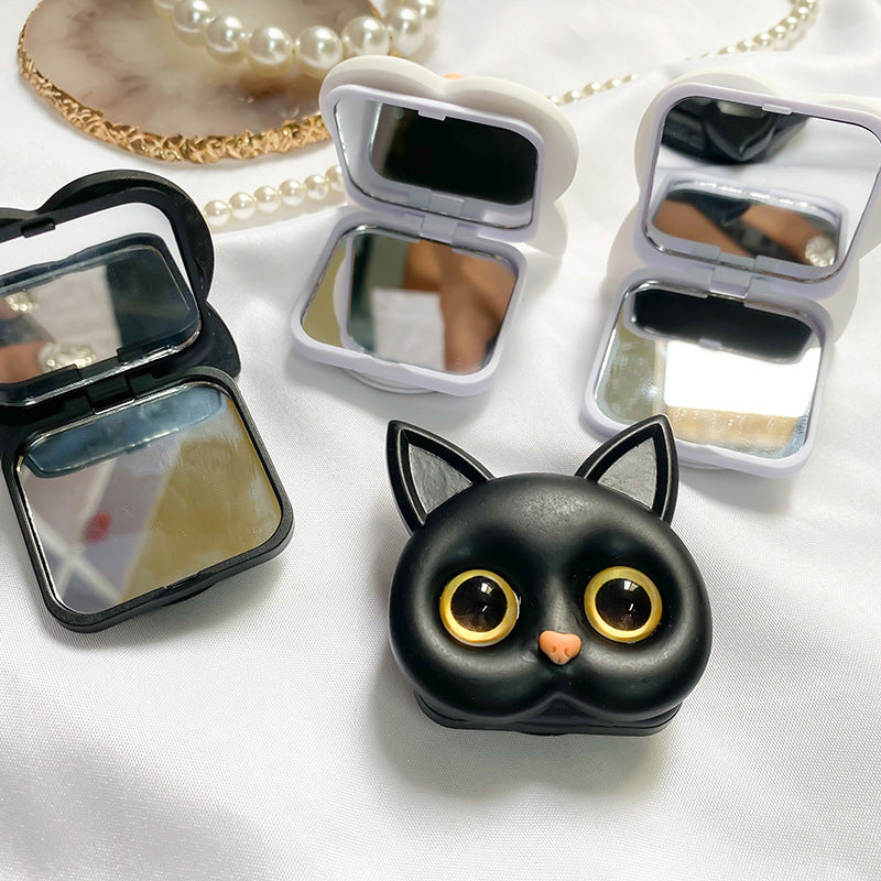 "Søt 3D Cat-telefonholder med minispeil i gull og blå øyne; hvit telefonholder med dekorativ kattedesign."