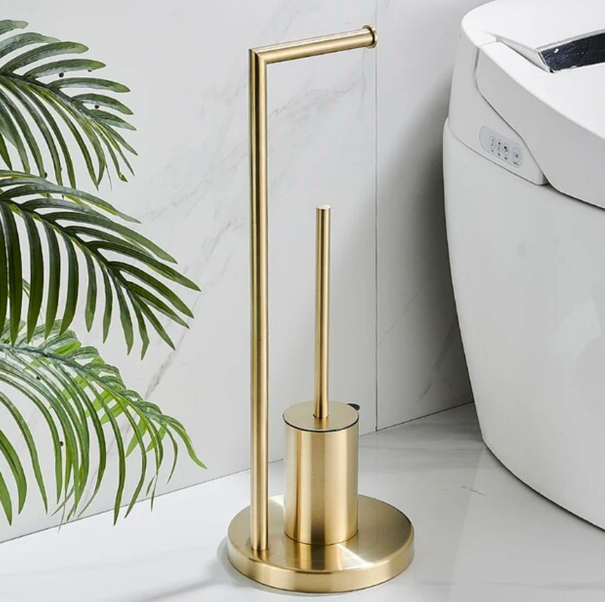 Elegant toalettrullholder med integrert børste i gull, perfekt for et stilig og hygienisk baderom.