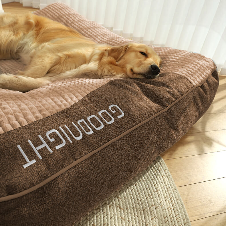 "Tykk ripebeskyttende hundeseng, myk, slitesterk med ryggstøtte, beige farge, i rom med stilfull innredning."