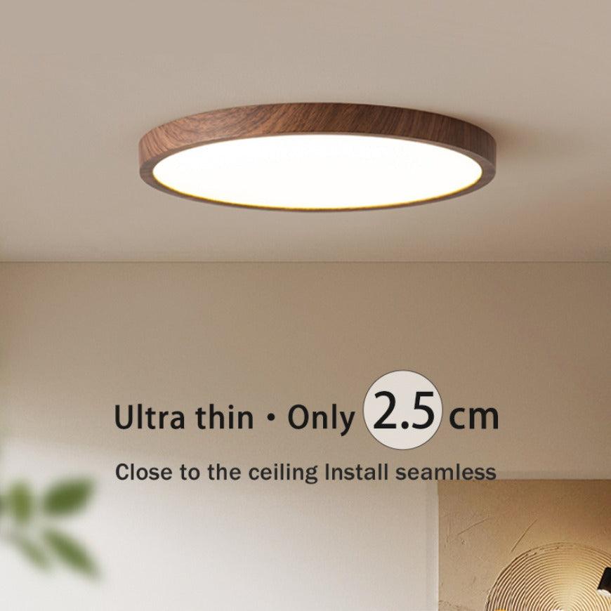 "Ultratynn sirkulær taklampe med justerbare lyseffekter og elegant valnøttdesign for moderne interiør."