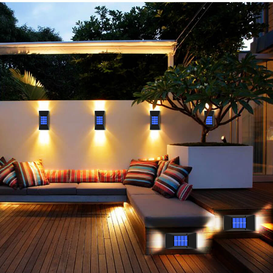 Detalj av en solcelledrevet vegglampe, viser solcellepanel og LED-lys, terrasselampe