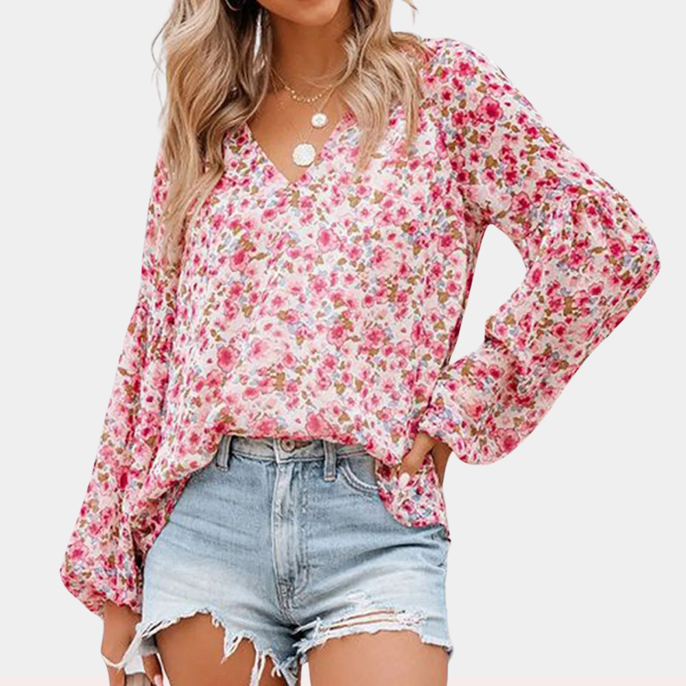 Amya Blomstret Sommerbluse; elegant bluse i livlige farger og blomsterdesign, perfekt for sommerlige anledninger.