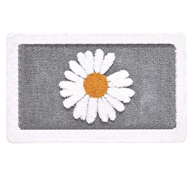 Sklisikker baderomsmatte med tusenfryd design. Gir komfort, absorbering og er et vakkert badeinteriør.