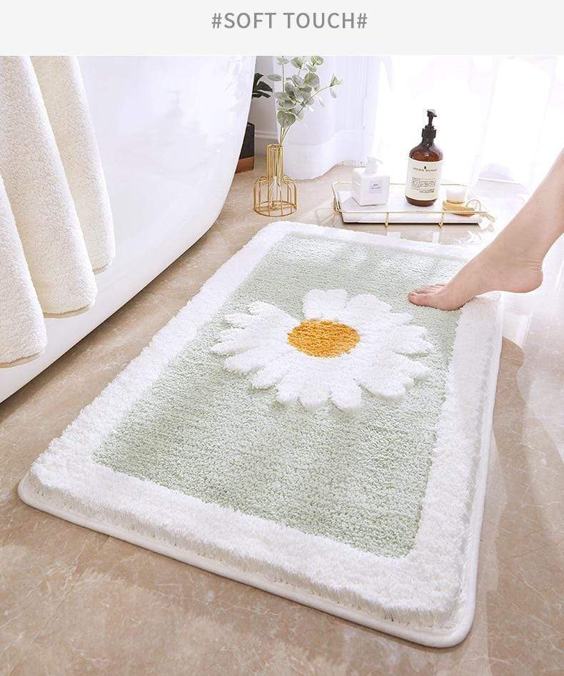Stilig baderomsmatte med tusenfryd blomster. Myk, sklisikker og lettstelt – perfekt for et trygt baderom.