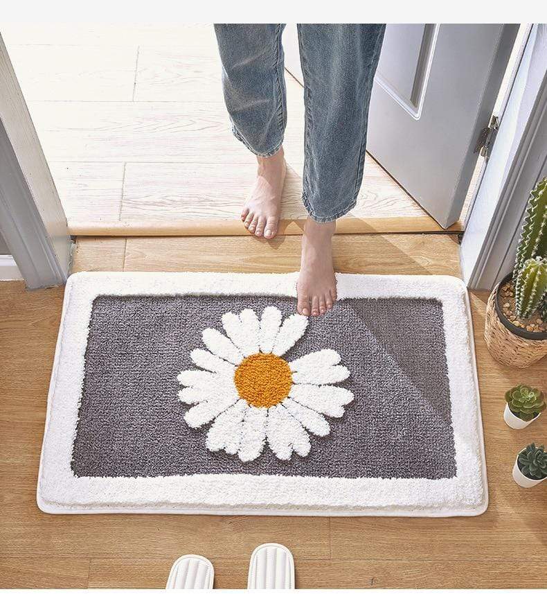 Baderomsmatte med friskt tusenfryd design. Sklisikker, absorberende og gir myk komfort til hvert baderom.