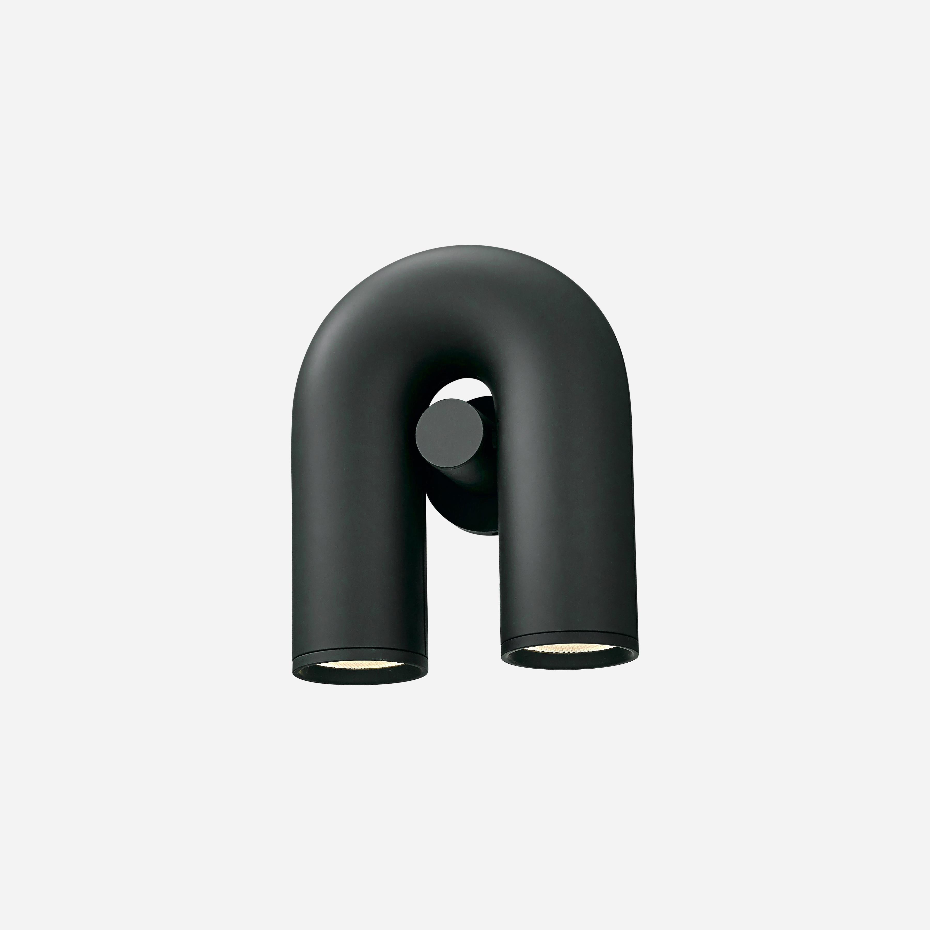 "Cirkus justerbar LED vegglampe med U-formet modul, elegant design for moderne innendørs belysning."