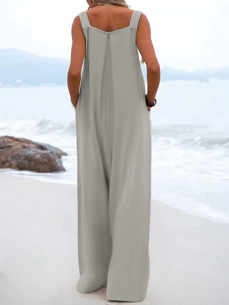 Damemote: Ensfarget jumpsuit med brede bukseseler, avslappet og stilfull for sommer og ferie.