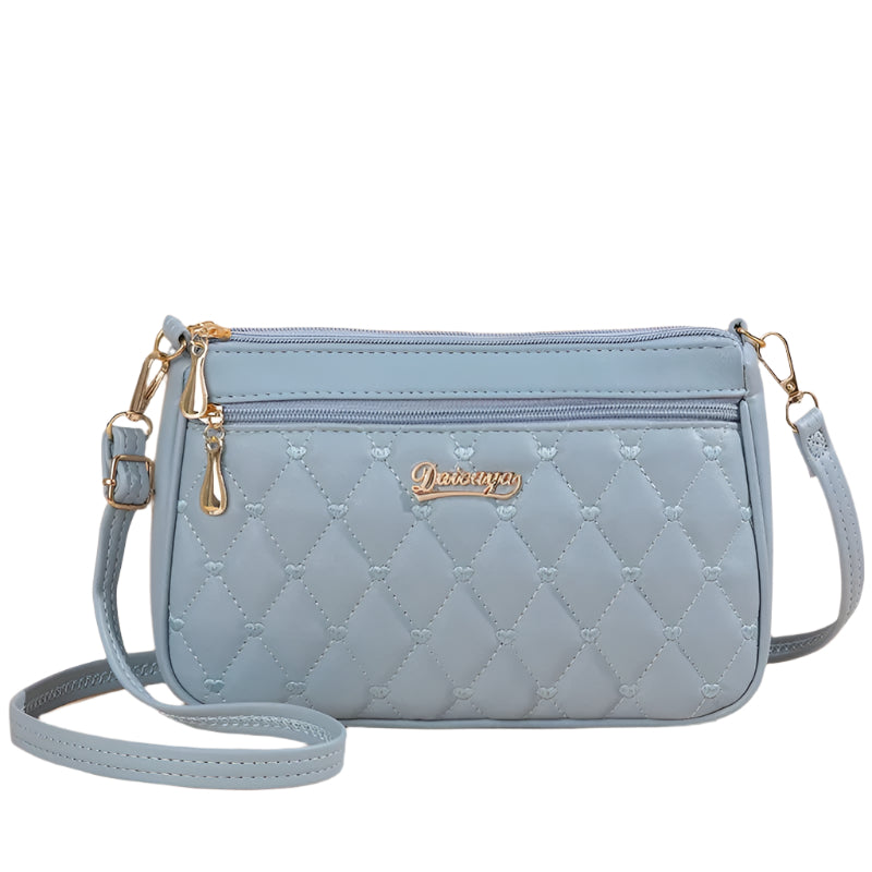Nærbilde av glidelåslukking på brodert crossbody-veske i PU-skinn for kvinner, et praktisk tilbehør.