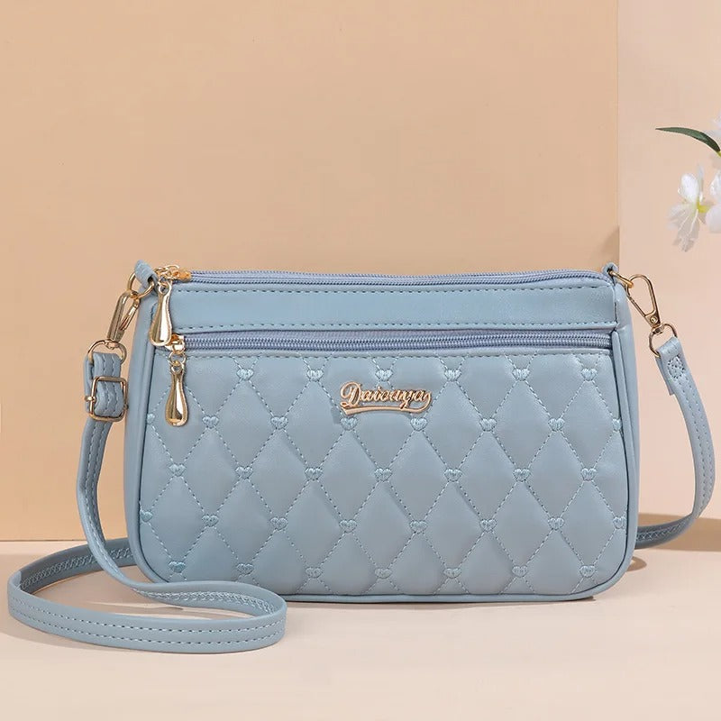 Brodert mønster på en elegant crossbody-veske i PU-skinn, et must-have tilbehør for kvinner.