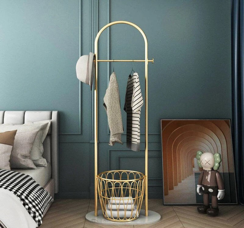 Interiørdetalj: Elegant gyllent klesstativ med kontrastrik svart marmorbase. Ideell for moderne hjemmeinnredning.