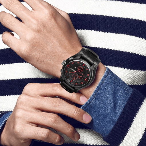 Herreklokke navigator med minimalistisk urskive, sølvfarget urkasse og solid svart skinnrem.
