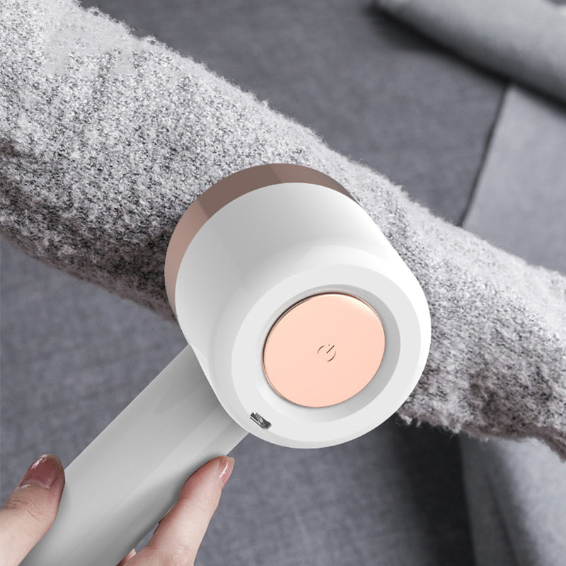 Elegant hvit nuppefjerner i ABS/PC og stål for skånsom oppfriskning av klær. Ergonomisk og trådløs med sikkerhetsmekanisme.