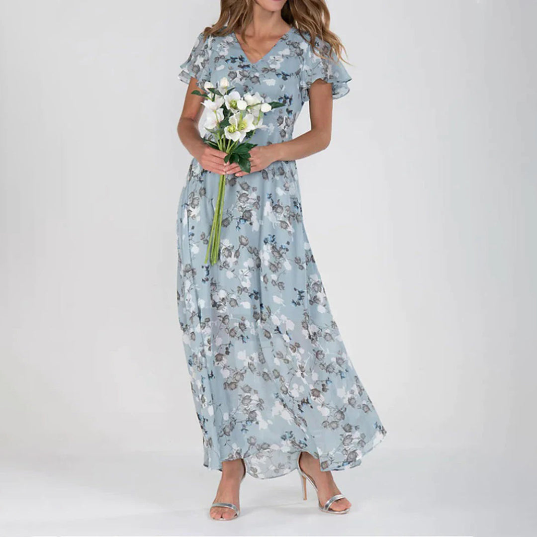 "Elegant maxikjole med blomster, grønn og himmelblå. Perfekt snitt, luftig og komfortabel for sommerdager."