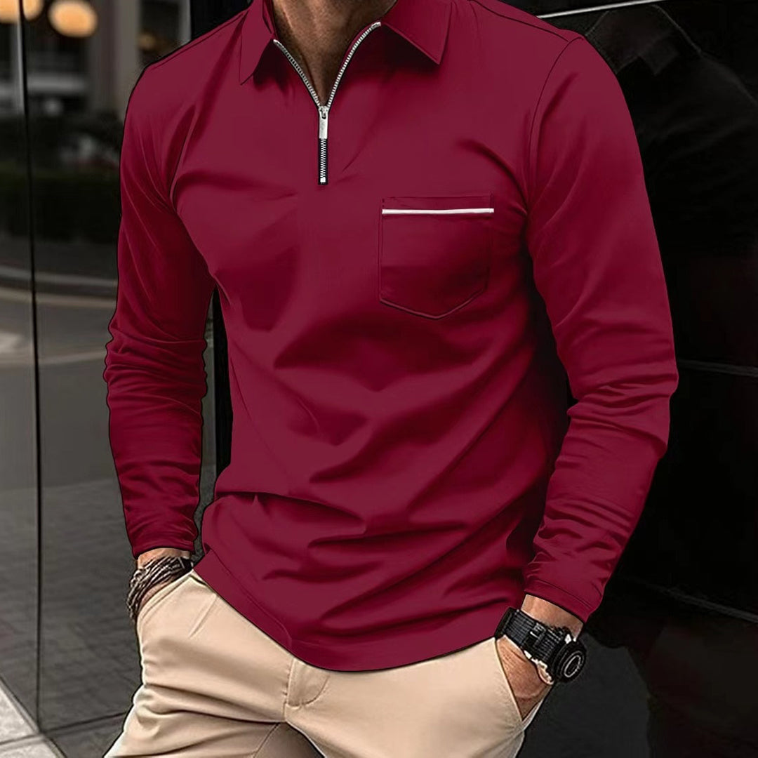 Herre poloshirt med glidelåskrage, lange ermer og brystlomme. Tidløst design for den stilbevisste.