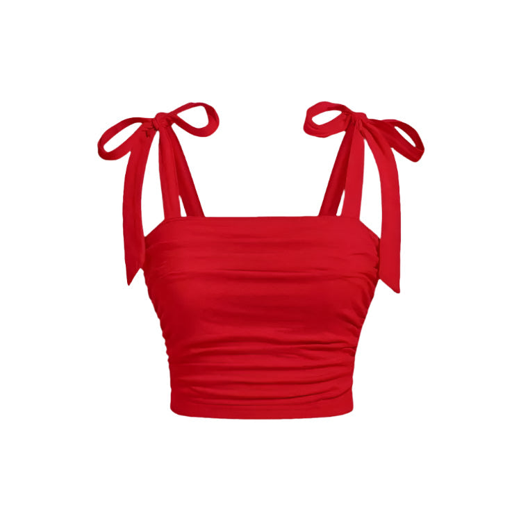 Feminin dame crop top med rysjer og bindeskulder. Perfekt for en stilig og komfortabel sommerlook.