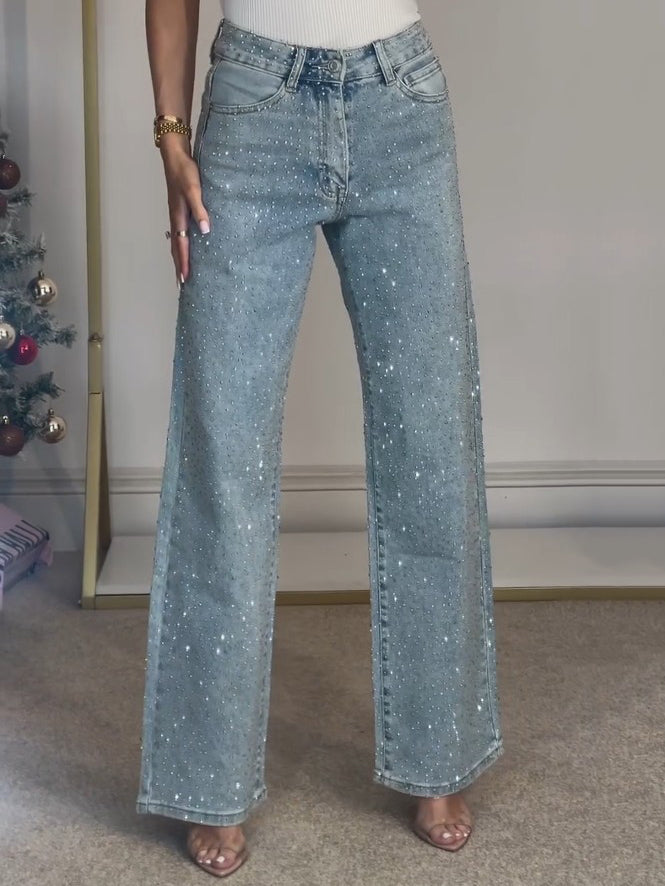 Komfortable mørkeblå damejeans med høy midje, glitrende detaljer, ideelle for casual eller formell look.