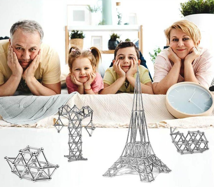 Hånd holder magnetisk pinne og kule, viser materialkvalitet og enkel tilkobling for barn