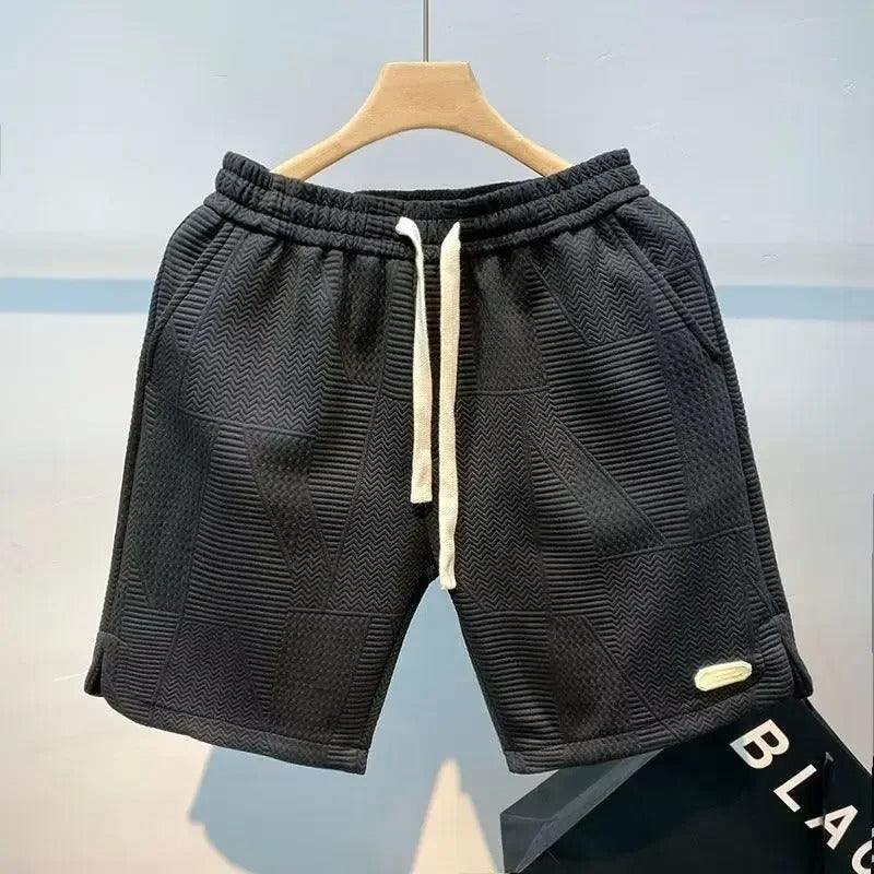 Komfortable herreshorts med løs passform og elastisk linning, perfekt for sport og avslappet sommerstil.