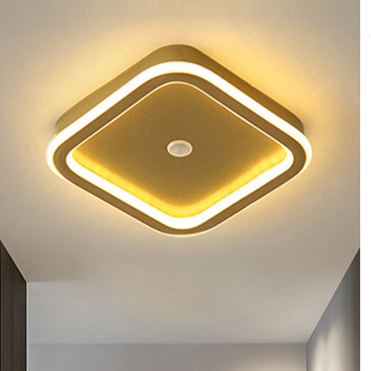 "Moderne LED-taklampe i metall med bevegelsessensor, energieffektiv, i svart og gull, stilrent design."