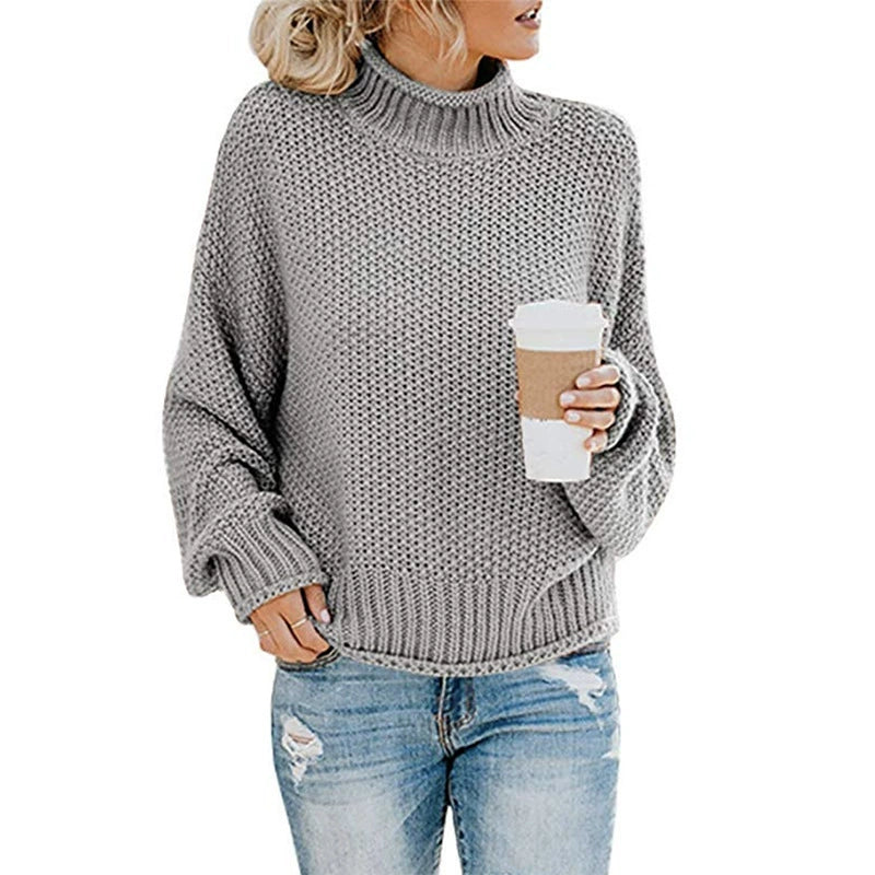Trendy høstgenser for damer: oversized strikkegenser med elegant høy hals og unike batwing-ermer. Myk og varm.