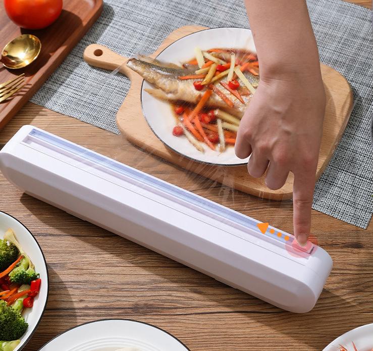 "Plastfoliekutter på kjøkken, slitesterkt ABS, moderne design med toveis kutterhode, sikker bunn med mikrosug."
