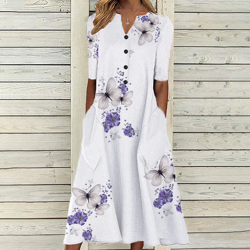Sommerkjole med blomster- og sommerfugltrykk, A-line snitt, V-hals, lommer, elegant og praktisk design, perfekt for varme dag