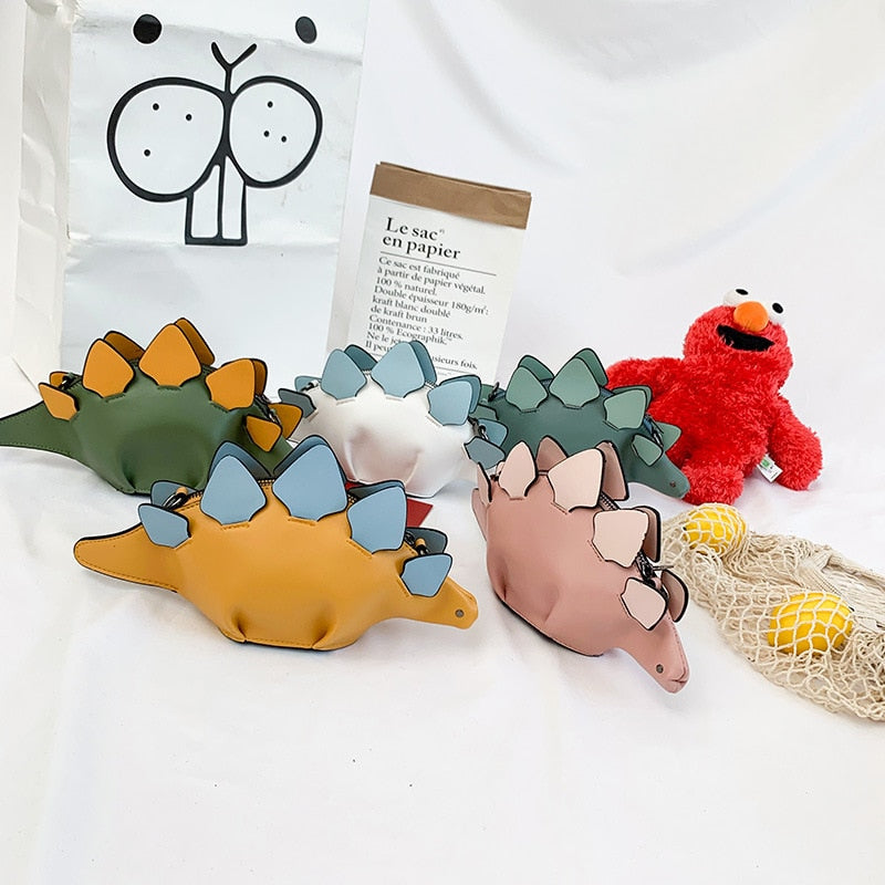 Grønn dinosaurveske, en populær crossbody-veske for barn. Perfekt for oppbevaring av små skatter.