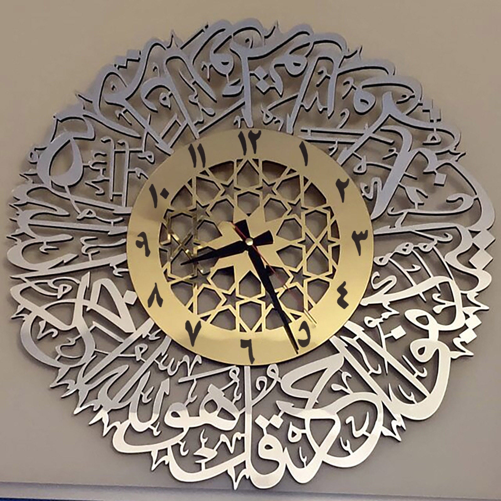 Nærbilde av veggklokke med intrikat arabisk kalligrafi design, elegant interiørdetalj
