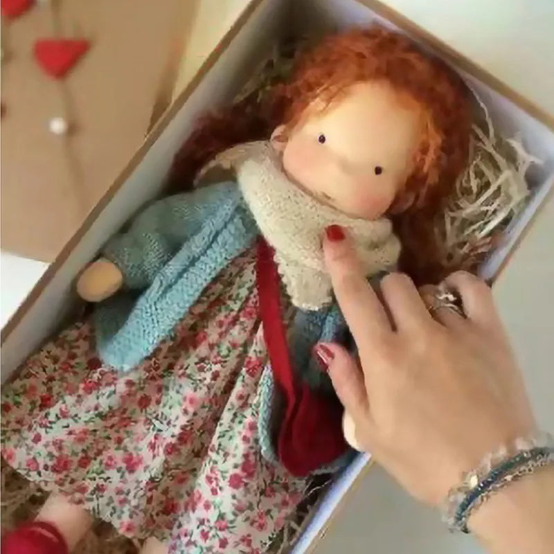 Waldorf-dukke som sitter, viser sin fleksibilitet, en populær håndlaget mykdukke.